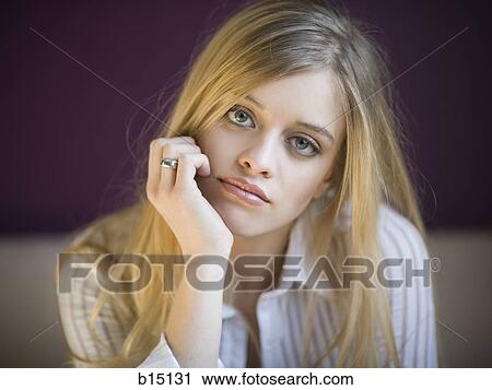 Stock Image - Closeup of woman resting hand on face. Fotosearch