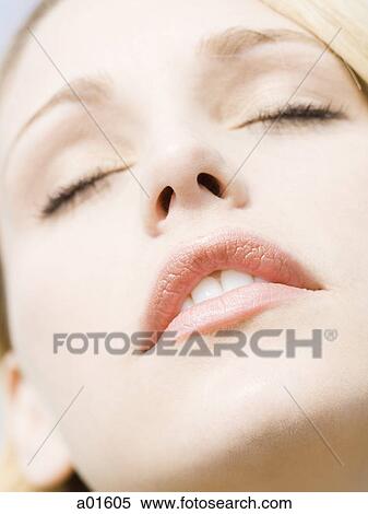 Stock Photography - Closeup of woman with eyes closed. Fotosearch