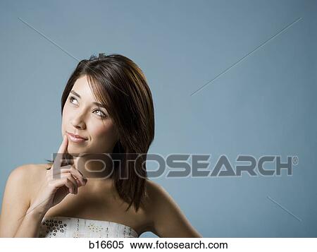 Closeup of woman with hand on mouth looking up View Large Photo Image Stock Photography - Closeup of woman with hand on mouth looking up. Fotosearch