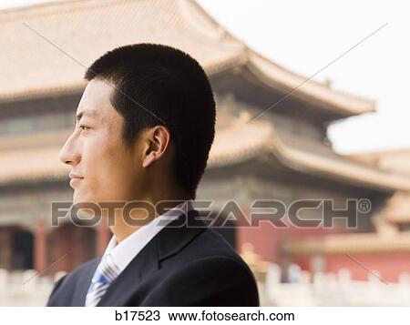 Stock Image - Closeup profile of businessman outdoors. Fotosearch