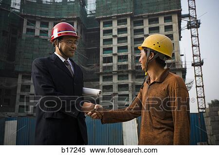 Construction foreman and worker outdoors shaking hands View Large Photo Image Stock Photography - Construction foreman and worker outdoors shaking hands. Fotosearch