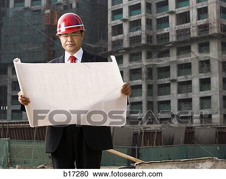 Construction site foreman with blueprints outdoors View Large Photo Image Stock Image - Construction site foreman with blueprints outdoors. Fotosearch