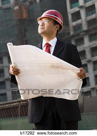 Construction site foreman with blueprints outdoors View Large Photo Image Stock Image - Construction site foreman with blueprints outdoors. Fotosearch