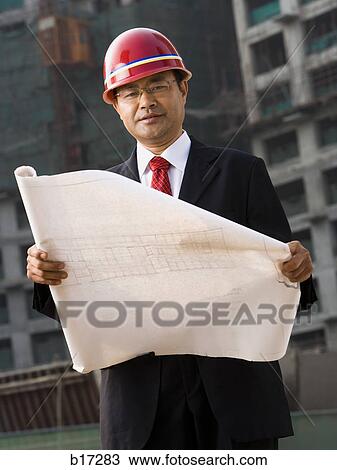 Construction site foreman with blueprints outdoors View Large Photo Image Stock Image - Construction site foreman with blueprints outdoors. Fotosearch