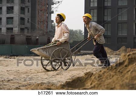 Construction worker giving other worker ride in wheelbarrow View Large Photo Image Stock Image - Construction worker giving other worker ride in wheelbarrow. Fotosearch