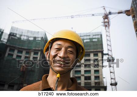 Construction worker outdoors with helmet smiling View Large Photo Image Stock Image - Construction worker outdoors with helmet smiling. Fotosearch