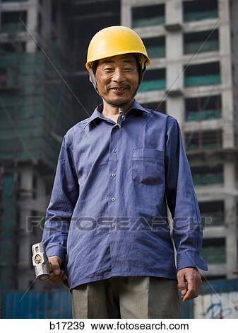 Construction worker outdoors with helmet smiling View Large Photo Image Stock Photo - Construction worker outdoors with helmet smiling. Fotosearch