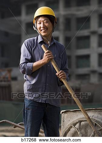 Construction worker outdoors with helmet smiling View Large Photo Image Stock Photo - Construction worker outdoors with helmet smiling. Fotosearch
