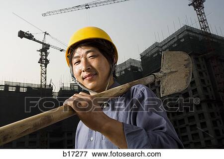 Construction worker outdoors with helmet smiling View Large Photo Image Stock Photo - Construction worker outdoors with helmet smiling. Fotosearch