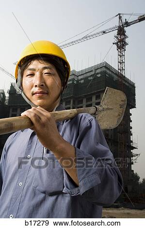 Construction worker outdoors with helmet smiling View Large Photo Image Stock Photo - Construction worker outdoors with helmet smiling. Fotosearch