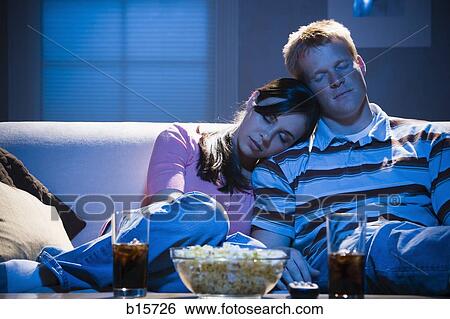 Couple asleep on sofa with bowl of popcorn View Large Photo Image Stock Photograph - Couple asleep on sofa with bowl of popcorn. Fotosearch