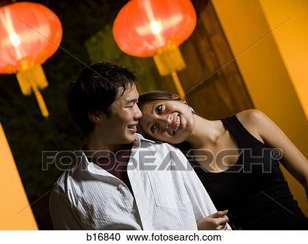 Couple embracing outdoors at night smiling View Large Photo Image Stock Image - Couple embracing outdoors at night smiling. Fotosearch