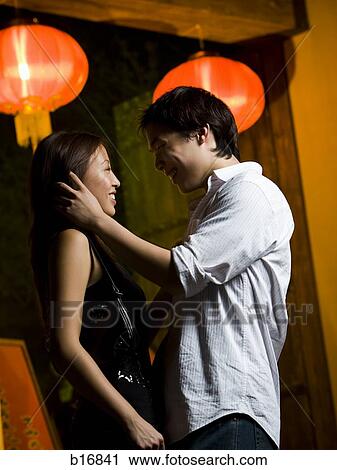Couple embracing outdoors at night smiling View Large Photo Image Stock Image - Couple embracing outdoors at night smiling. Fotosearch