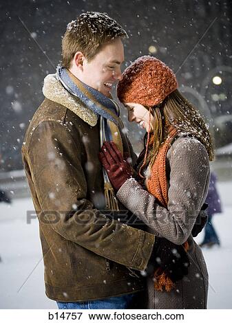 Stock Photo - Couple embracing outdoors in winter. Fotosearch