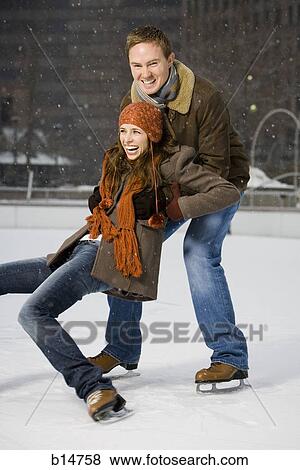 Couple falling while ice skating View Large Photo Image Stock Photo - Couple falling while ice skating. Fotosearch