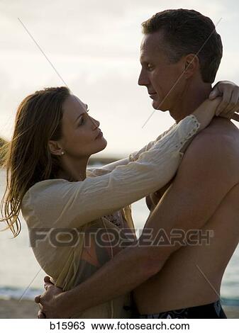 Couple hugging on beach View Large Photo Image Stock Image - Couple hugging on beach. Fotosearch