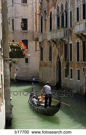 Couple in gondola on canal with historic buildings View Large Photo Image Stock Image - Couple in gondola on canal with historic buildings. Fotosearch