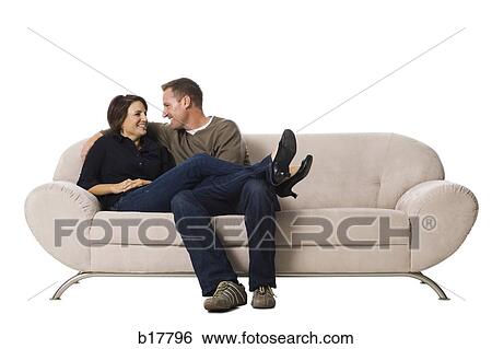 Stock Photograph - Couple sitting on a couch.. Fotosearch