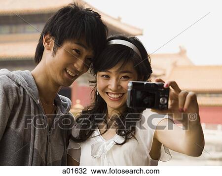 Couple taking a picture. View Large Photo Image Stock Image - Couple taking a picture.. Fotosearch