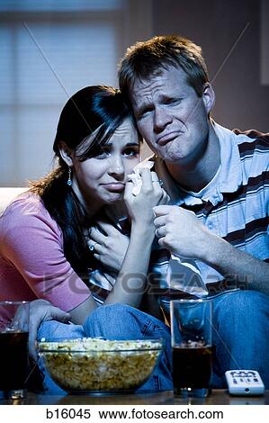 Couple watching television with bowl of popcorn and tissue crying View Large Photo Image Stock Photography - Couple watching television with bowl of popcorn and tissue crying. Fotosearch