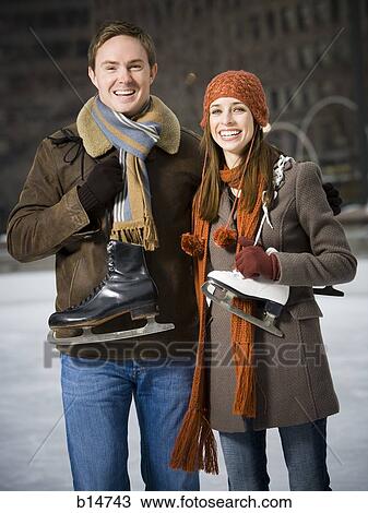 Couple with skates outdoors in winter View Large Photo Image Stock Image - Couple with skates outdoors in winter. Fotosearch