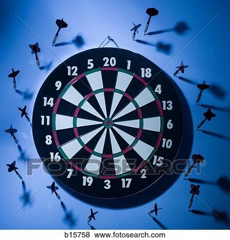 Stock Photo - Dartboard with darts on wall. Fotosearch
