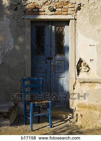 Detail of door with empty wooden chair View Large Photo Image Stock Photo - Detail of door with empty wooden chair. Fotosearch