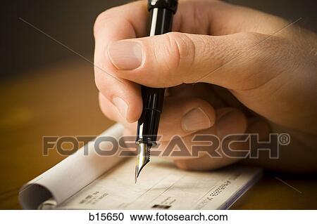Detailed view of man holding fountain pen and endorsing check View Large Photo Image Stock Image - Detailed view of man holding fountain pen and endorsing check. Fotosearch