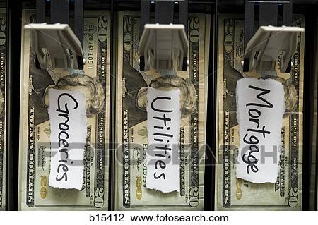 Stock Image - Detailed view of US currency in till with labels for household expenses. Fotosearch