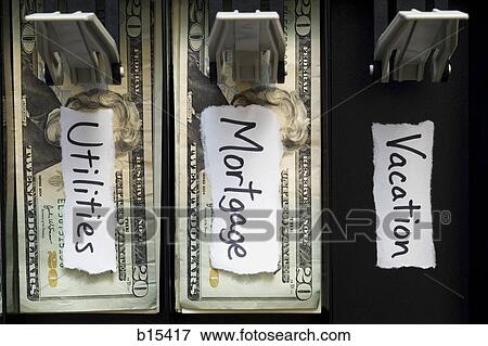 Detailed view of US currency in till with mortgage and utilities labels and no vacation money View Large Photo Image Stock Photo - Detailed view of US currency in till with mortgage and utilities labels and no vacation money. Fotosearch