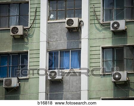 Stock Photo - Detailed view of windows in apartment building with air conditioning units. Fotosearch
