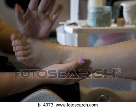 Stock Image - Detailed view of woman having pedicure. Fotosearch