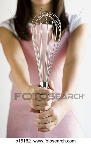 Detailed view of woman holding whisk View Large Photo Image Stock Image - Detailed view of woman holding whisk. Fotosearch