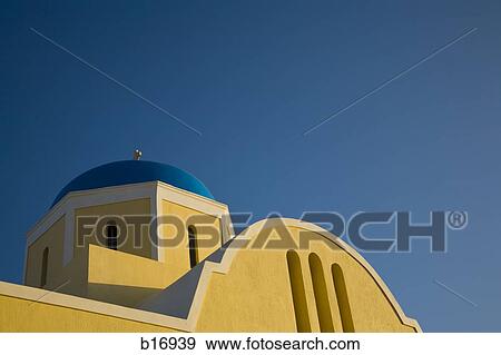 Stock Photo - Detailed view of yellow church with blue sky. Fotosearch