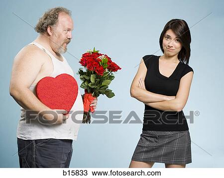 Disheveled man with heart box and red roses with disinterested woman View Large Photo Image Stock Image - Disheveled man with heart box and red roses with disinterested woman. Fotosearch