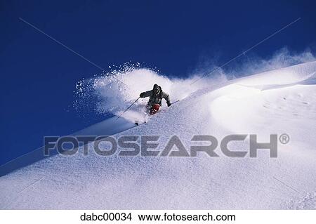 Downhill skier skiing on mountain View Large Photo Image Picture - Downhill skier skiing on mountain. Fotosearch