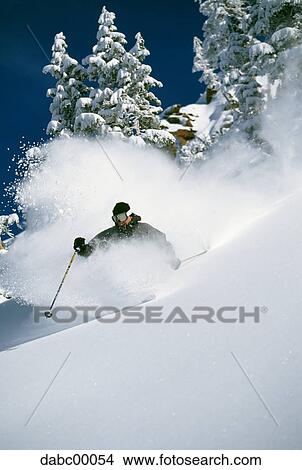 Downhill skier skiing on mountain View Large Photo Image Picture - Downhill skier skiing on mountain. Fotosearch