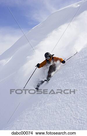 Downhill skier skiing on mountain View Large Photo Image Picture - Downhill skier skiing on mountain. Fotosearch