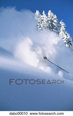 Downhill skier skiing on mountain View Large Photo Image Stock Image - Downhill skier skiing on mountain. Fotosearch