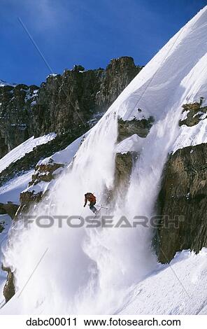 Downhill skier skiing on mountain View Large Photo Image Stock Image - Downhill skier skiing on mountain. Fotosearch