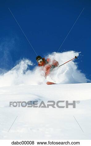 Downhill skier skiing on mountain View Large Photo Image Stock Photo - Downhill skier skiing on mountain. Fotosearch