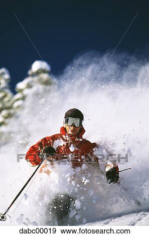 Downhill skier skiing on mountain View Large Photo Image Stock Photo - Downhill skier skiing on mountain. Fotosearch