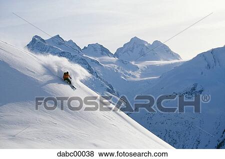 Downhill skier skiing on mountain View Large Photo Image Stock Photo - Downhill skier skiing on mountain. Fotosearch
