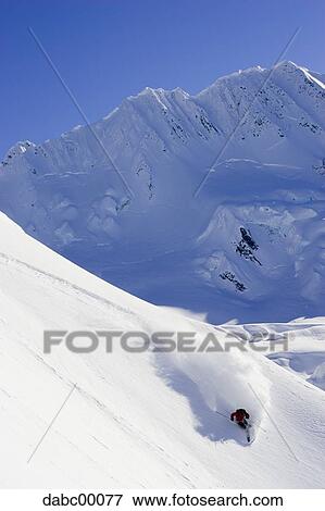 Downhill skier skiing on mountain View Large Photo Image Stock Photo - Downhill skier skiing on mountain. Fotosearch