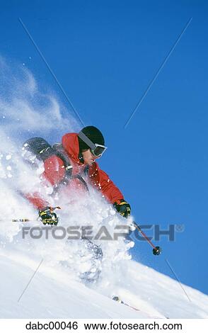 Downhill skier skiing on mountain View Large Photo Image Stock Photograph - Downhill skier skiing on mountain. Fotosearch