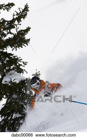Downhill skier skiing on mountain View Large Photo Image Stock Photograph - Downhill skier skiing on mountain. Fotosearch