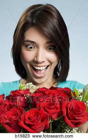 Excited woman with red roses View Large Photo Image Stock Image - Excited woman with red roses. Fotosearch
