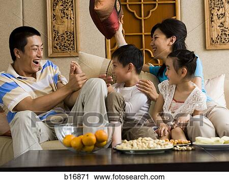 Family having pillow fight on sofa laughing View Large Photo Image Stock Image - Family having pillow fight on sofa laughing. Fotosearch