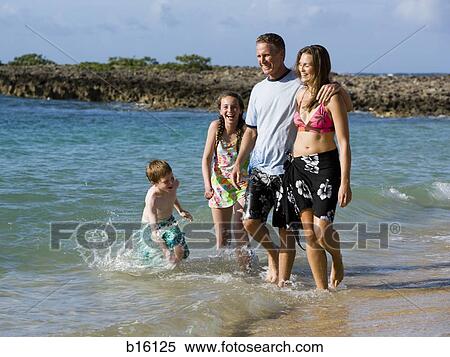 Family of four playing in water outdoors laughing View Large Photo Image Stock Photography - Family of four playing in water outdoors laughing. Fotosearch