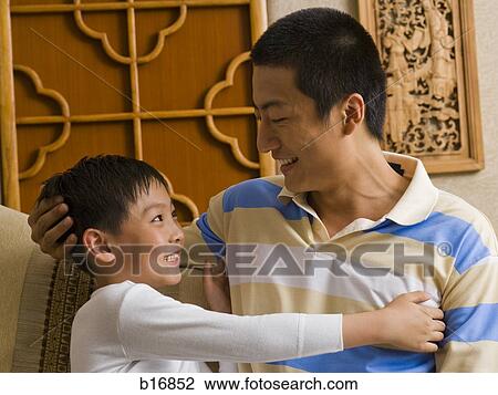 Father and son embracing View Large Photo Image Stock Image - Father and son embracing. Fotosearch